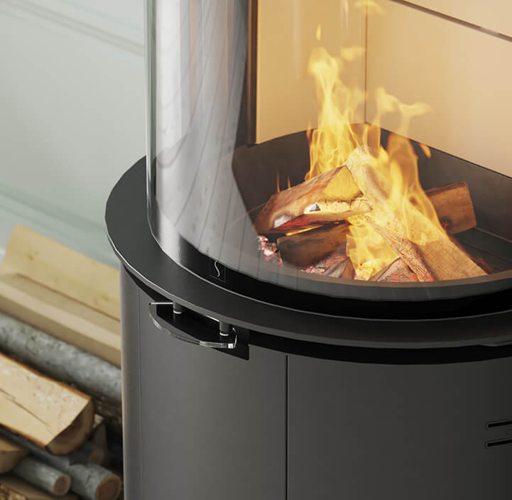 Detail image of Black wood stove Scan 87 with glass handle and wood in the background