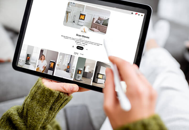 Close-up of hands holding a tablet and scrolling on pinterest