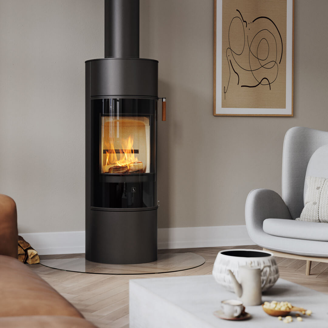 Wood-burning stove Scan 84 with black glass door in a bright interior