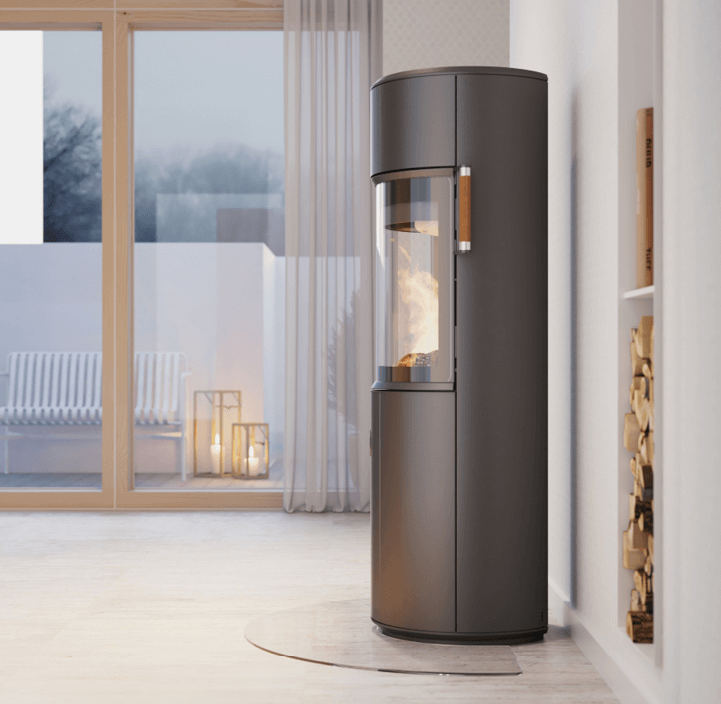 Wood stove with D-form Scan 67 from the side in a bright Scandinavian interior