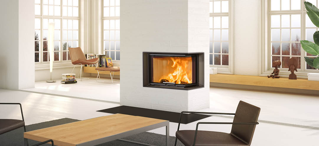 Large white fireplace with black fireplace insert Scan 5004 with lift-up door and glass on two sides, located in the middle of the white living room with large windows with sprouce and bench behind