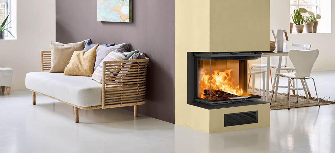 White living room with bamboo sofa and a purple wall with fireplace on end wall and fireplace insert Scan 5004 FRL with glass on three sides