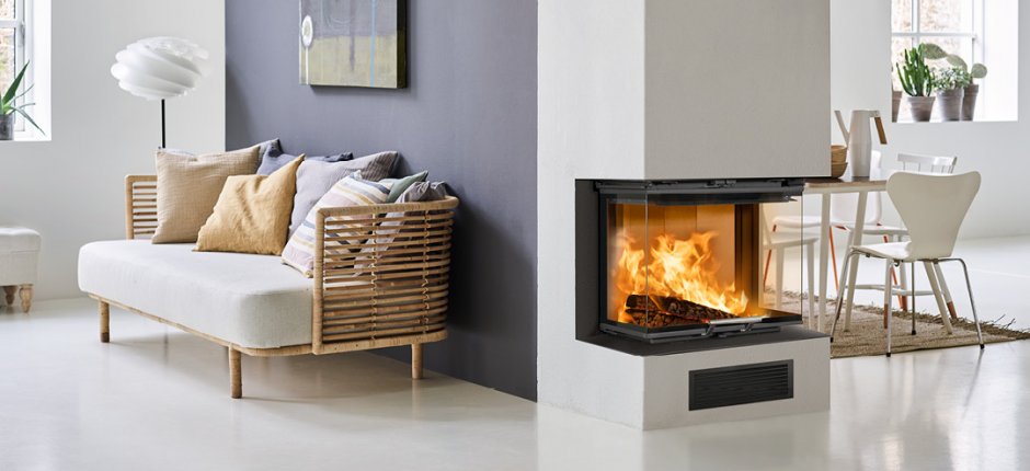 Scan 5004 large fireplace insert with lifting door in a white living room with a purple wall