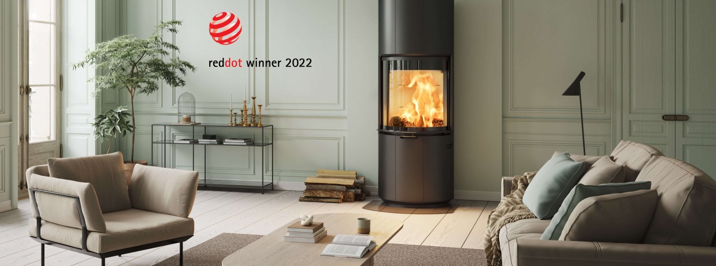 Black fireplace Scan 87 and log Red Dot Award Winner 2022 in light green interior with light brown sofa and recliner