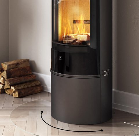 Black fireplace that can be rotated, placed on light herringbone patterned floor