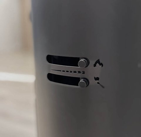 The side of the black Scan 68 wood stove with intuitive air controls