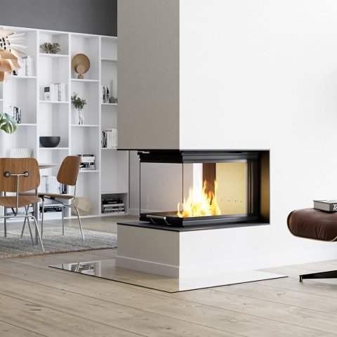 Fireplace insert Scan 5005 with glass on three sides in a large room-dividing fireplace installation in a gray living room with light floors